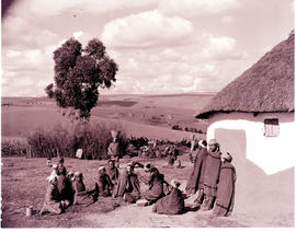 "Umtata district, 1957.Group of people at hut."