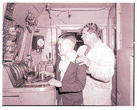 "1957. Blue Train driver with boy in locomotive cabin."