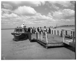 Vaal Dam, circa 1949. Arrival of BOAC flying boat Solent G-AKNS. Passengers disembarking from pas...