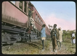 Botswana. Buying native curios from a train.