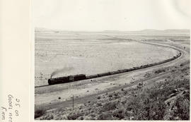 Beaufort West district, 1960. Goods train headed by SAR Class 25 in open country near Nelspoort.