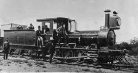 Cape Town. Men posing with CGR 1st Class of 1875 No 7 at Bellville station.