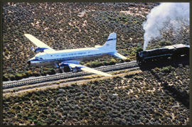 SAA Historic Flight Douglas DC-4 ZS-BMH flying over SAR Class 15F oil fired locomotive. Outeniqua...