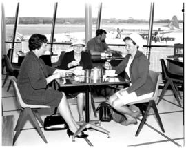 East London, 1968. Ben Schoeman airport. Sitting at table in cafeteria with view on SAA Vickers V...