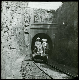 Group on inspection trolley emerging from tunnel.