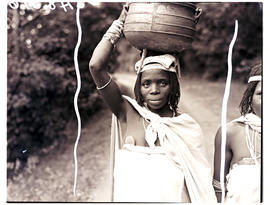Transkei, 1940. Woman carrying pot on head.