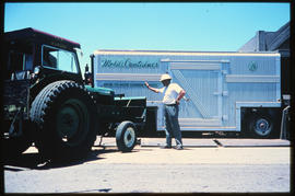 
Tractor and mobile container at goods depot.
