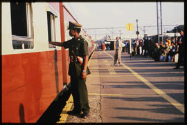 Johannesburg, October 1984. Railway policeman on platform at Kempton Park railway station. [T Rob...