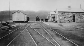 Laingsburg, 1895. Station buildings with steam locomotive and station staff in the distance looki...