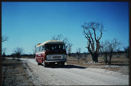 Etosha Game Park, Namibia, 1968. SAR GUY tour bus on gravel road.