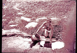 "Eshowe district, 1929. Zulu girl collecting water from puddle."