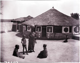 Pretoria district, 1952. Ndebele kraal, family at decorated wall and gate.
