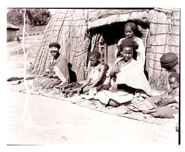 Natal, 1946. Zulu women and children in front of hut.