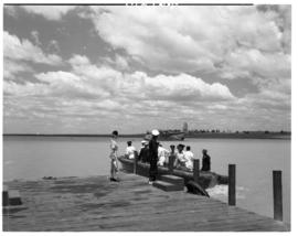 Vaal Dam, circa 1949. Arrival of BOAC flying boat Solent G-AKNS. Luggage boat at jetty.