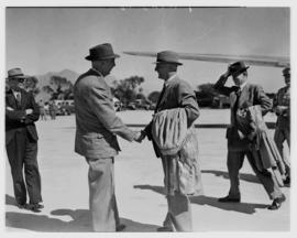 May 1946. Trip to Cape Town with SAA Douglas DC-4 ZS-AUA 'Tafelberg', men greeting outside aircraft.