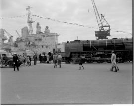 Cape Town, 20 April 1947. SAR Class 15F No 3030 with 'HMS Vanguard' in Table Bay Harbour.