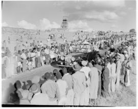 West Rand, 2 April 1947. Daimler greeted by crowd with mining headgear in the distance.