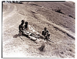 Transkei, 1940. Three people sitting at roadside.