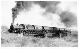 Mahalapye, 1897. CGR 8th Class with train on bridge with four spans.