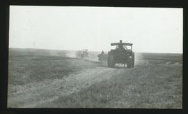 Tractors on dusty road. SAR Marshall Colonial Type F tractor in front.
