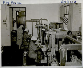 "Pietermaritzburg, 1946. Two ladies at weaving looms, making carpets."