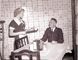 Johannesburg, January 1957. Railway policeman being served in cafeteria.