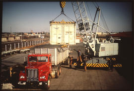 Mobile crane loading container onto SAR truck.