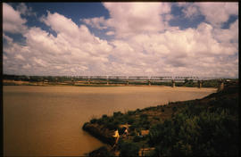 Steel bridge over wide river.