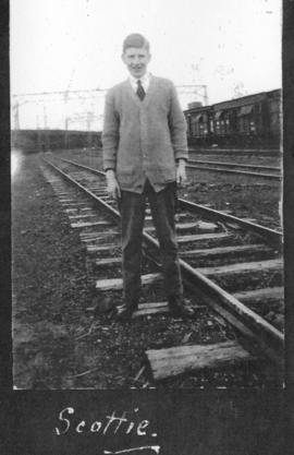 Circa 1925. 'Scottie' posing at railway line. (Album on Natal electrification)