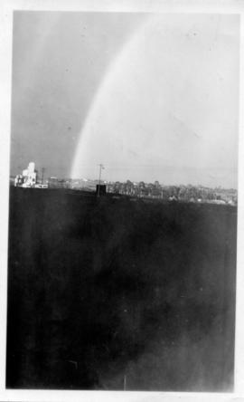 Rainbow over village in the distance. (Lund collection)