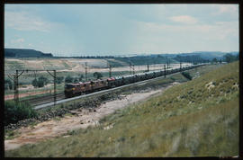 Johannesburg. 1981. Motor car train passing mine dump.