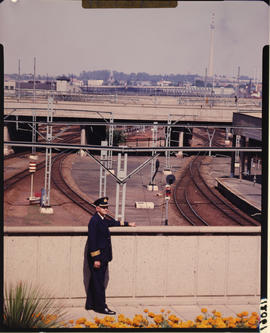 Johannesburg. Station master on bridge overlooking railway tracks.