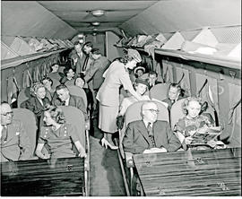 
SAA Douglas DC-4 interior with passengers and hostess.
