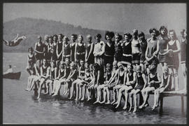 Group of young girls in bathing costumes at pier.