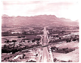"Cape Town, 1971. Aerial view of Blue Train crossing highway."