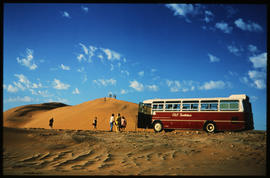 Swakopmund district , South-West Africa, 1976. SAR Mercedes Benz tour bus at sand dune.