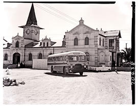 Swakopmund, South-West Africa, 1961. SAR MT16630 tour bus at railway station. The convertible car...