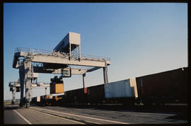 Durban, 1986. Containers loaded onto train with gantry crane in Durban Harbour.