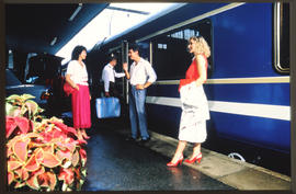 
Blue Train passengers on station platform.
