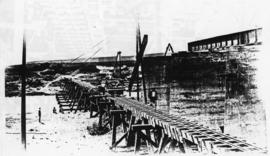 Humansdorp district, circa 1911. Gamtoos River bridge: Hoisting 40 feet girders onto piers off tr...