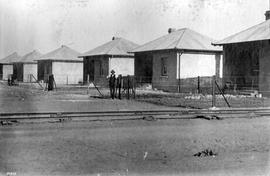 Beaufort West. Completed row of railway cottages directly next to railway line.