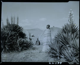 Zululand, 1956. Zulu woman wrapped in blanket in kraal.