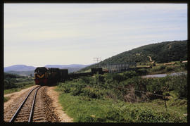 
SAR diesel locomotive with goods train on steel bridge.
