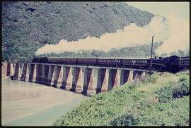 Wilderness district. Passenger train with two steam engines on Kaaimansrivier bridge.