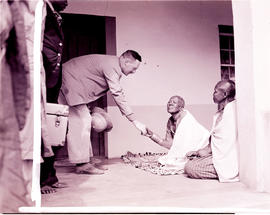 Tzaneen district, 1946. Queen Modjadji sitting with white man shaking hands.
