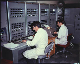Analytical chemists at a 50-channel direct readout emission spectrophotometer.