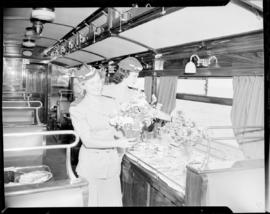 Cape Town, 1947. Travel hostesses arranging flowers in staff dining saloon No 219 'Protea'.