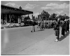Bulawayo, Southern Rhodesia, 15 April 1947. King George VI on dais salutes ex-servicemen marching...