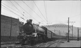 Cape Town. SAR Class 19B  with suburban passenger stock. Castle on left. (DF Holland Collection)