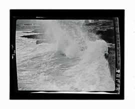 Hermanus, 1927. Waves breaking over rocks.